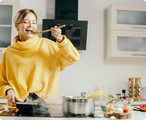 Woman cooking happily in kitchen