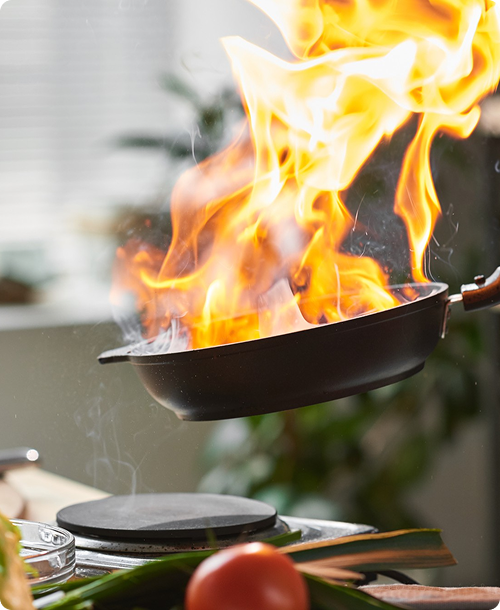 Cooking with fire and flame in kitchen