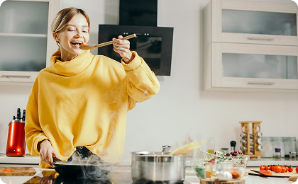 Woman in yellow sweater cooking
